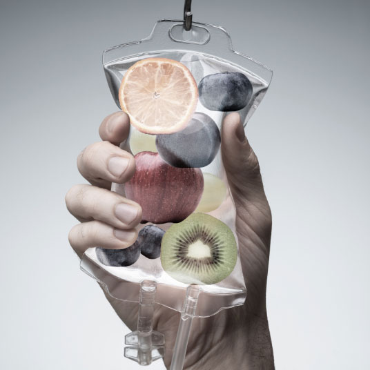 An IV bag filled with fruit to illustrate vitamins for weight loss