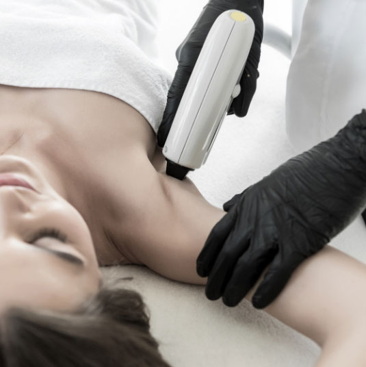 Woman receiving laser skin treatment hair removal on her armpit