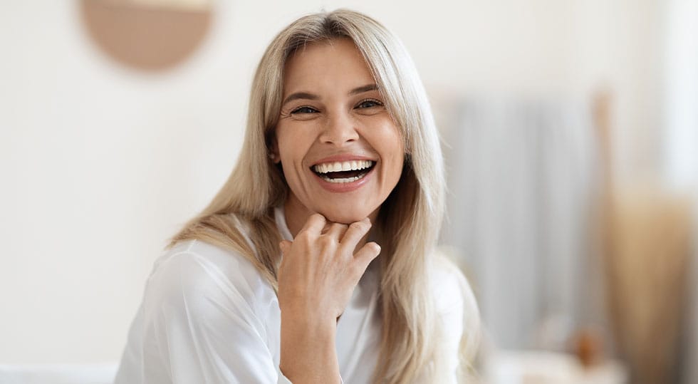 woman smiling after starting hormone therapy in Deerfield, IL